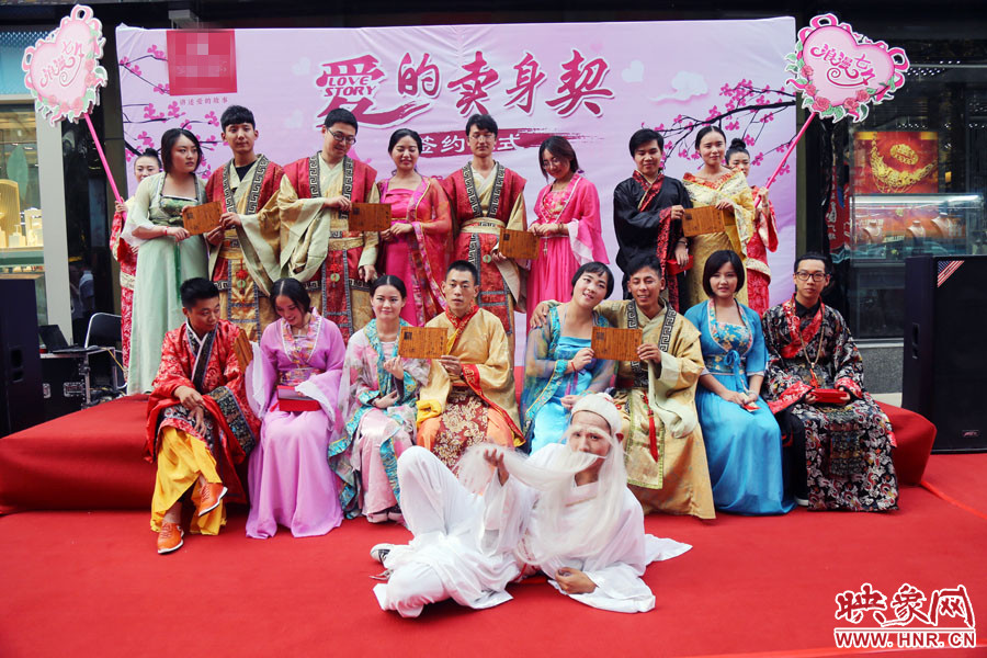 現(xiàn)場8對兒年輕男女舉起“賣身契”集體拍照。