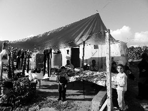 黎巴嫩一敘利亞難民營，難民支起攤鋪賣衣服掙錢。