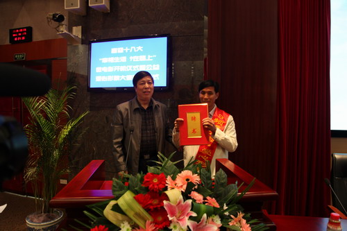 河南平頂山魯山縣電視臺的記者張朝岑，接過了河南電視臺9頻道總監(jiān)張克宣遞上的聘書。